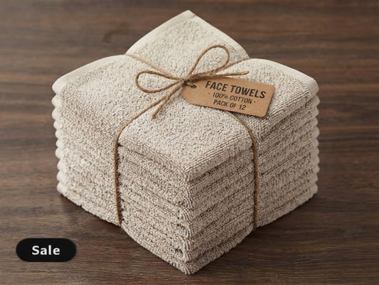 Cream cotton face towels stacked in a pack of 12 with a tag reading face towels, 100% cotton