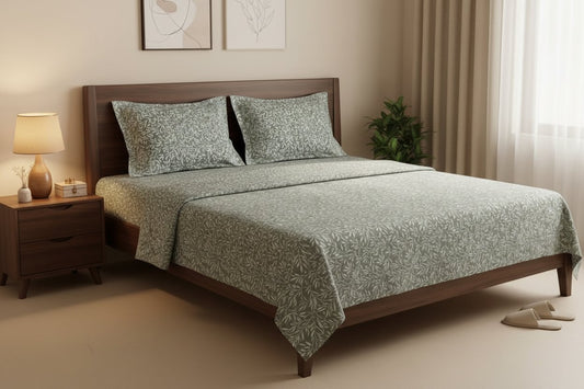Sage Willow Double Bedsheet Set with dense sage green and dusty blue willow leaf print on muted green-grey background, styled on a dark wood double bed with matching pillow covers