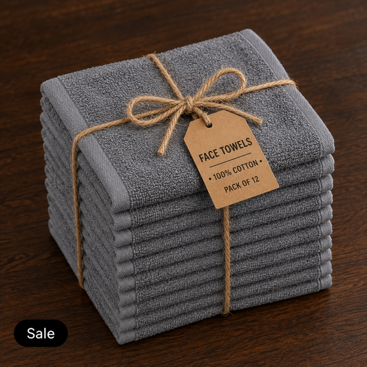 Stack of twelve grey cotton face towels tied with twine and a tag stating 100% cotton, pack of 12