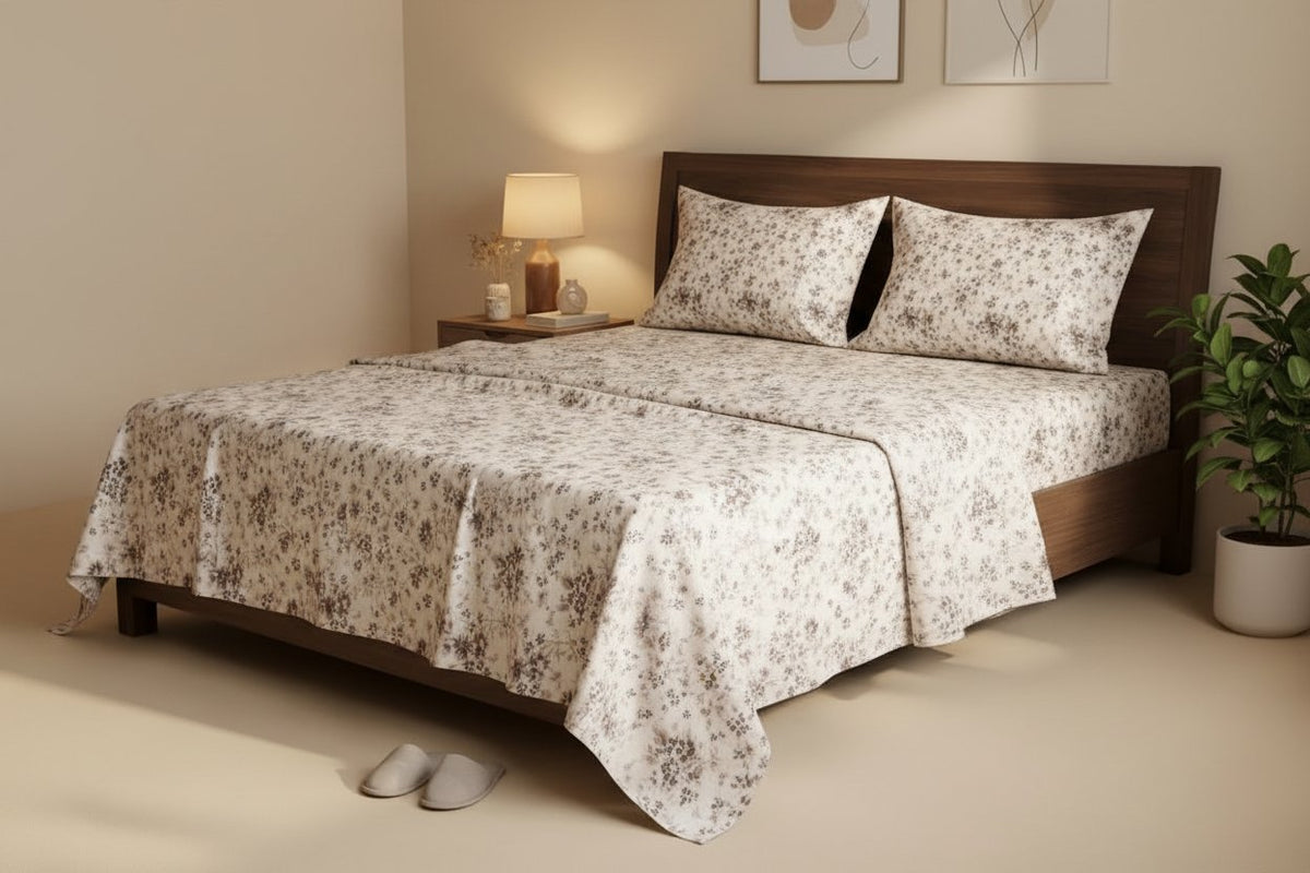 Autumn Ditsy King Bedsheet Set with all-over scattered taupe and brown wildflower ditsy print on white, styled on a dark wood king bed with two matching pillow covers